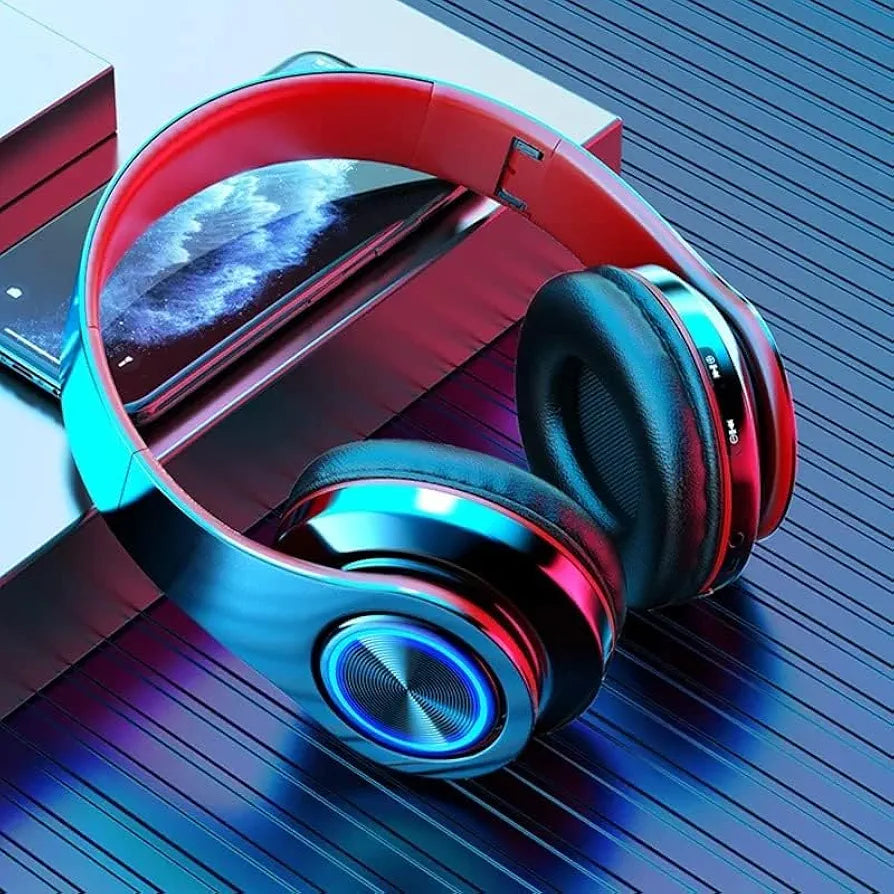 B39 Bluetooth Wireless Gaming Headset Foldable with luminous LED lights in black and red, shown beside a smartphone on a tech-themed surface.