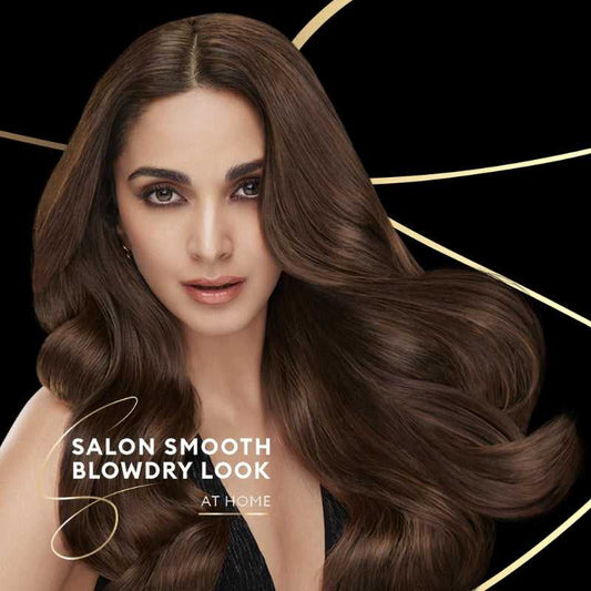 Model with voluminous, frizz-free hair showcasing salon-smooth blow-dry look achieved using Tresemme Keratin Smooth Shampoo.