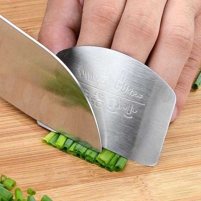 Stainless Steel Finger Guard - Safe Cutting Tool used while finely chopping herbs, ensuring finger protection and cutting accuracy in the kitchen.