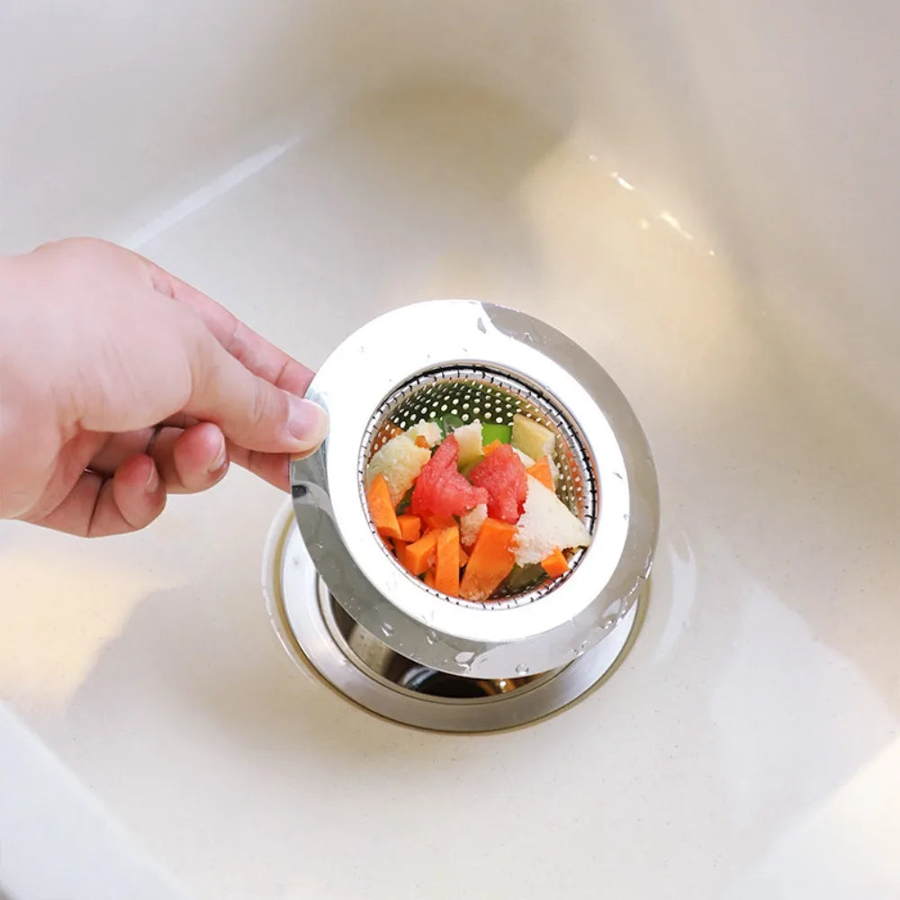 Stainless Steel Kitchen Sink Strainer Stopper from Bamagate.com filtering food scraps in a sink to prevent clogs and ensure smooth drainage.