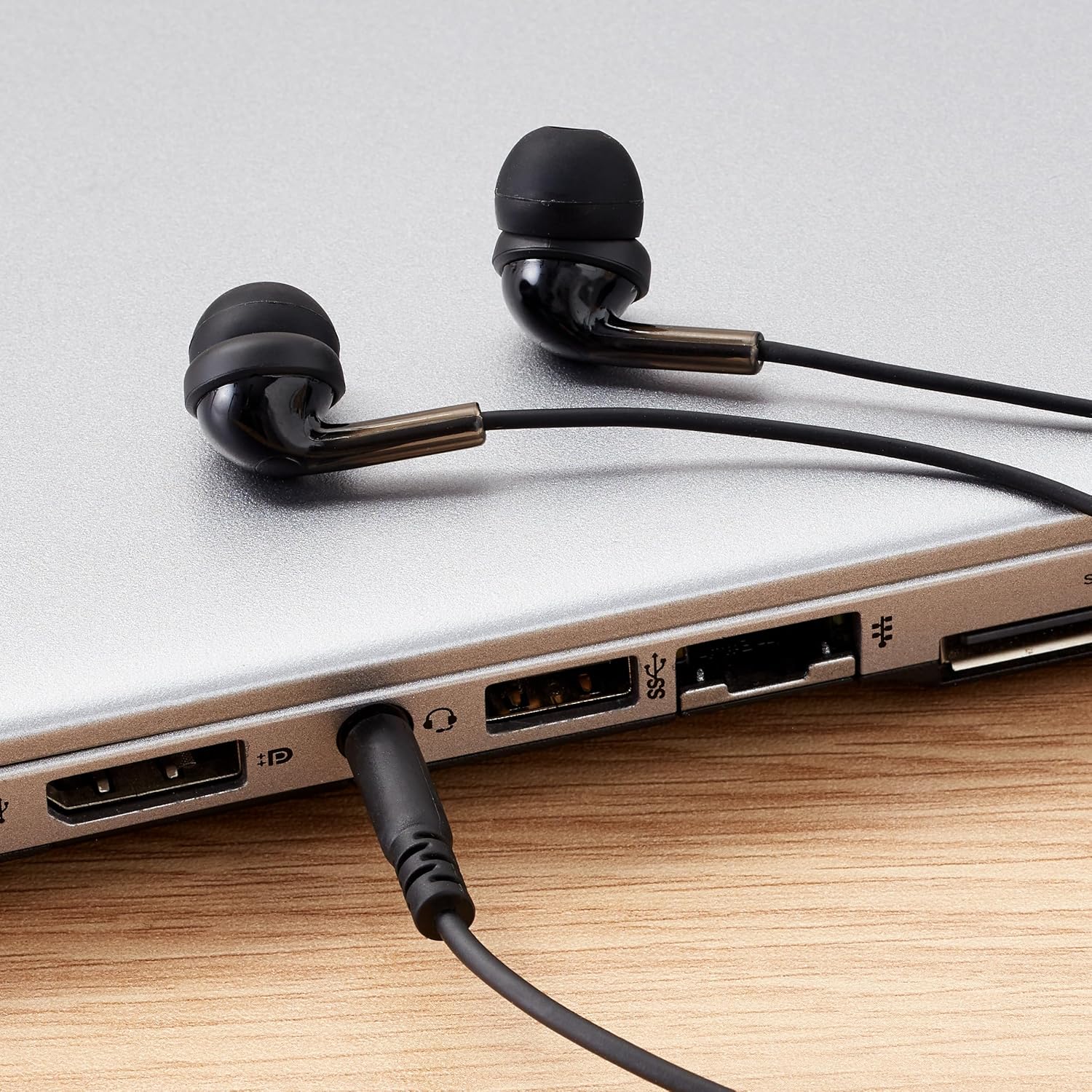 Celebrat G25 Wired Earphone in black connected to laptop via 3.5mm jack, perfect for music, calls, and multimedia use in Sri Lanka