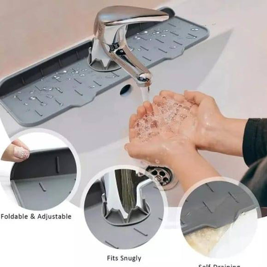 Kitchen Sink Portable Mat in use under faucet, catching water splashes while washing hands. Foldable, adjustable, and fits snugly around sink base.