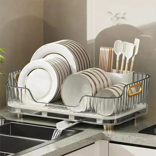 Acrylic Kitchen Plate Rack Shelf for Countertops with gold handles, holding plates and utensils beside a sink. Transparent design enhances visibility.