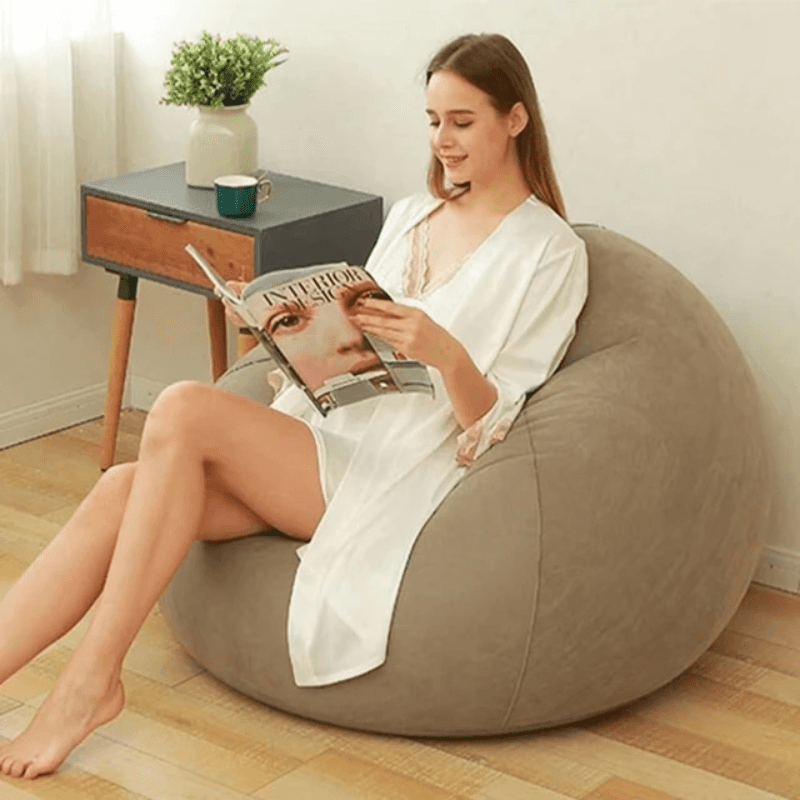 Portable Inflatable Lazy Chair in beige used indoors for reading, ideal for relaxed seating. Shop inflatable chair price at Bamagate.com.