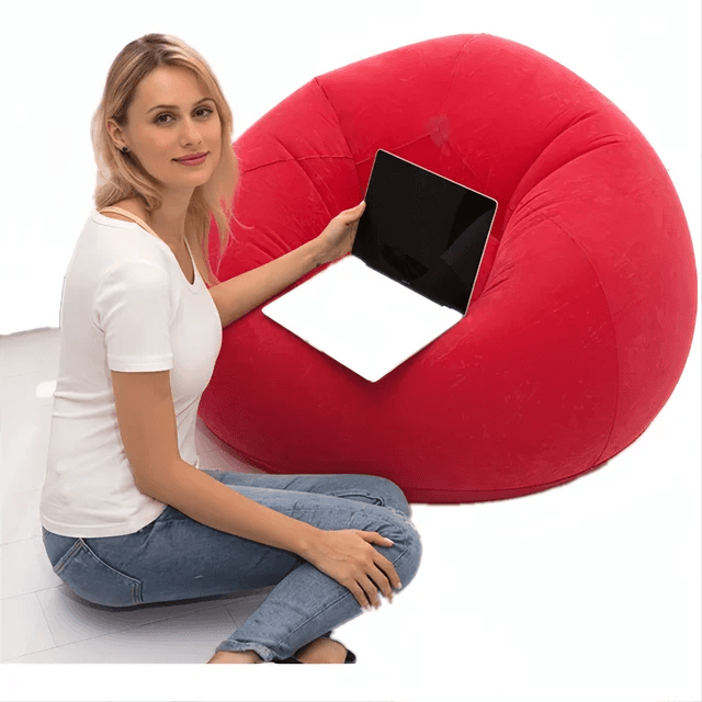 Red Portable Inflatable Lazy Chair used as a laptop support, showcasing versatile furniture. Explore inflatable chair options at Bamagate.com.