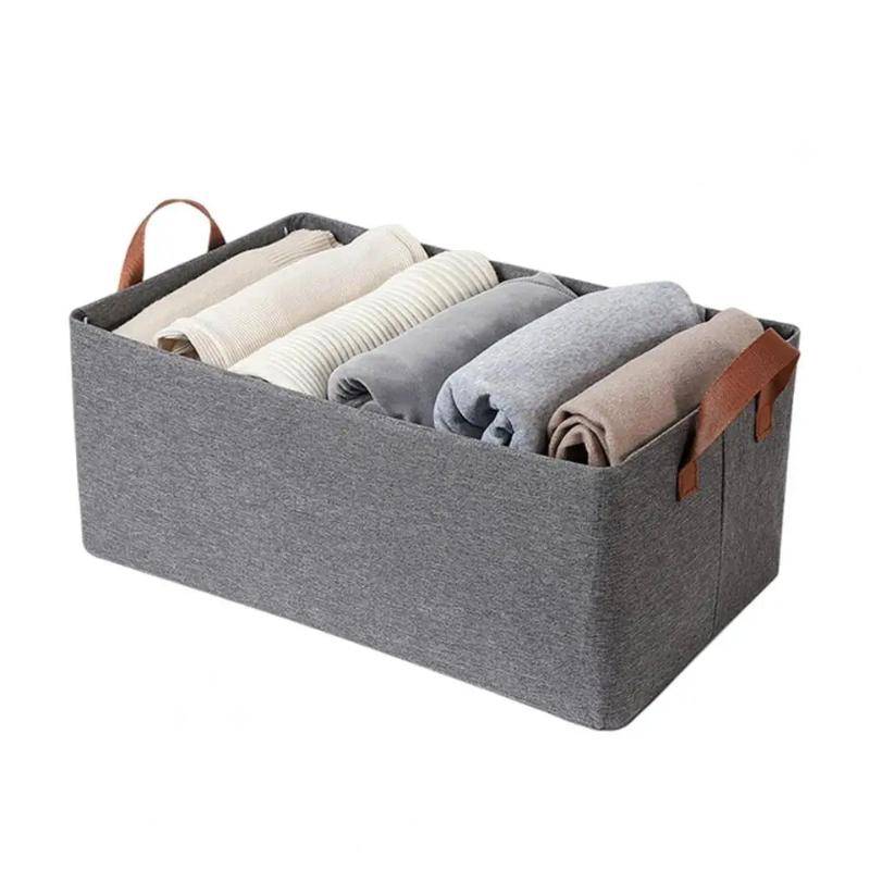 Wardrobe Cloth Storage Organiser - Space Saver with nonwoven fabric, featuring leather handles and neatly folded clothes inside.