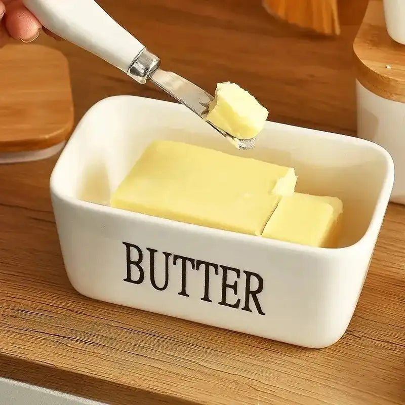 Close-up of ceramic butter dish with bamboo lid and knife, showing butter being spread. Perfect for kitchen and dining use in Sri Lanka homes.