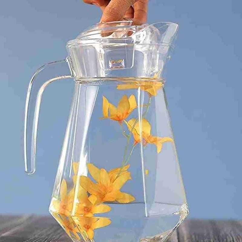 1.4L glass water jug with thermal-resistant design, ideal for serving cold drinks, shown with floral infusion on a wooden table.