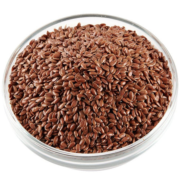 Nutritional Raw Flax Seeds 100 g in a clear glass bowl, rich in omega-3 and fiber for heart health and digestion. Ideal for cereals, baking, and smoothies.