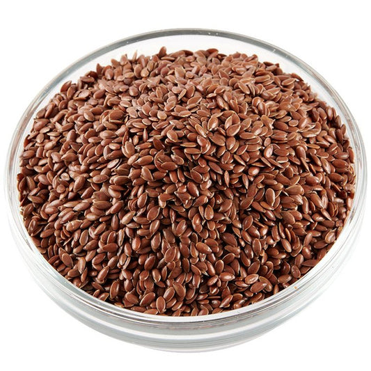 Nutritional Raw Flax Seeds 100 g in a clear glass bowl, rich in omega-3 and fiber for heart health and digestion. Ideal for cereals, baking, and smoothies.
