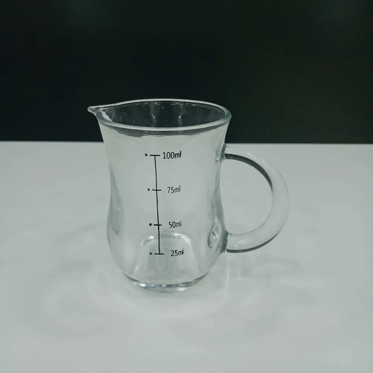 100 ml measuring glass from Bamagate with clear volume markings for 25ml to 100ml, ideal for precise kitchen measurements and liquid handling.