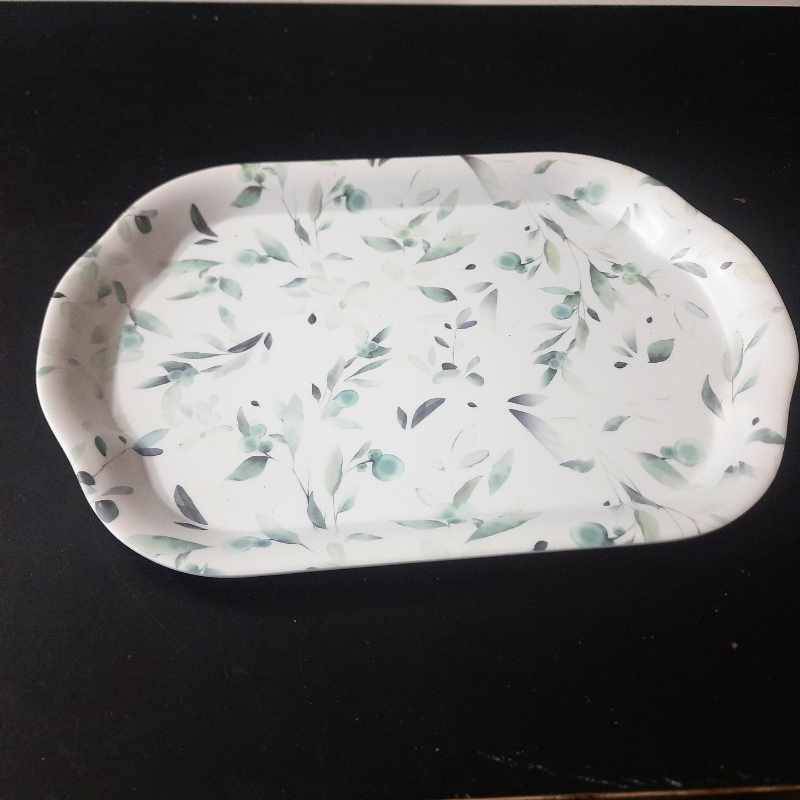 Elegant Green Leaf Melamine Tray on black surface, perfect for stylish food presentation. Affordable melamine plates price in Sri Lanka.