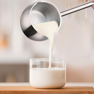 Mini Stainless Steel Measuring Melting Pot | Bamagate.com shown pouring milk into a glass, ideal for precise heating on induction, gas, or electric stoves.