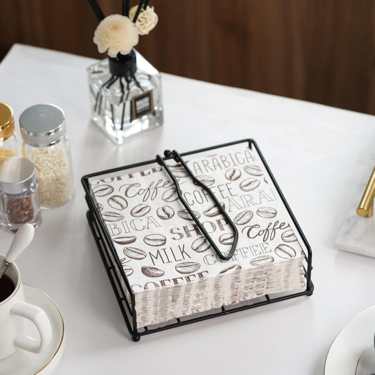 Stylish black metal napkin holder on a dining table, showcasing elegant tissue storage for home and kitchen decor.