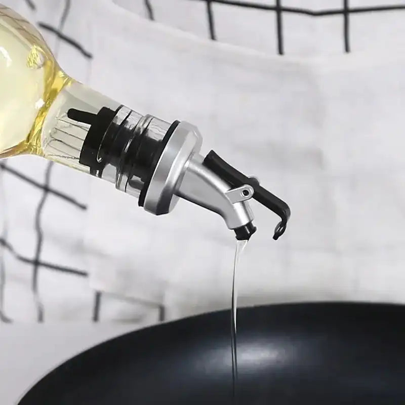 Pour Spout Leak-proof Oil Bottle Dispenser ensures controlled, mess-free oil pouring into a pan. Ideal for precise cooking in Sri Lankan kitchens.