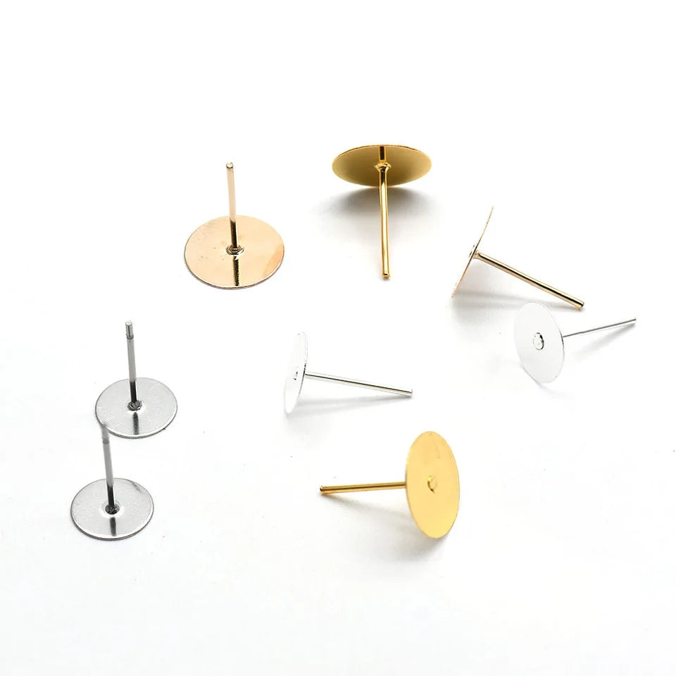 Assorted gold and silver earring pins with flat backs, perfect for DIY jewelry making and secure earring attachment.
