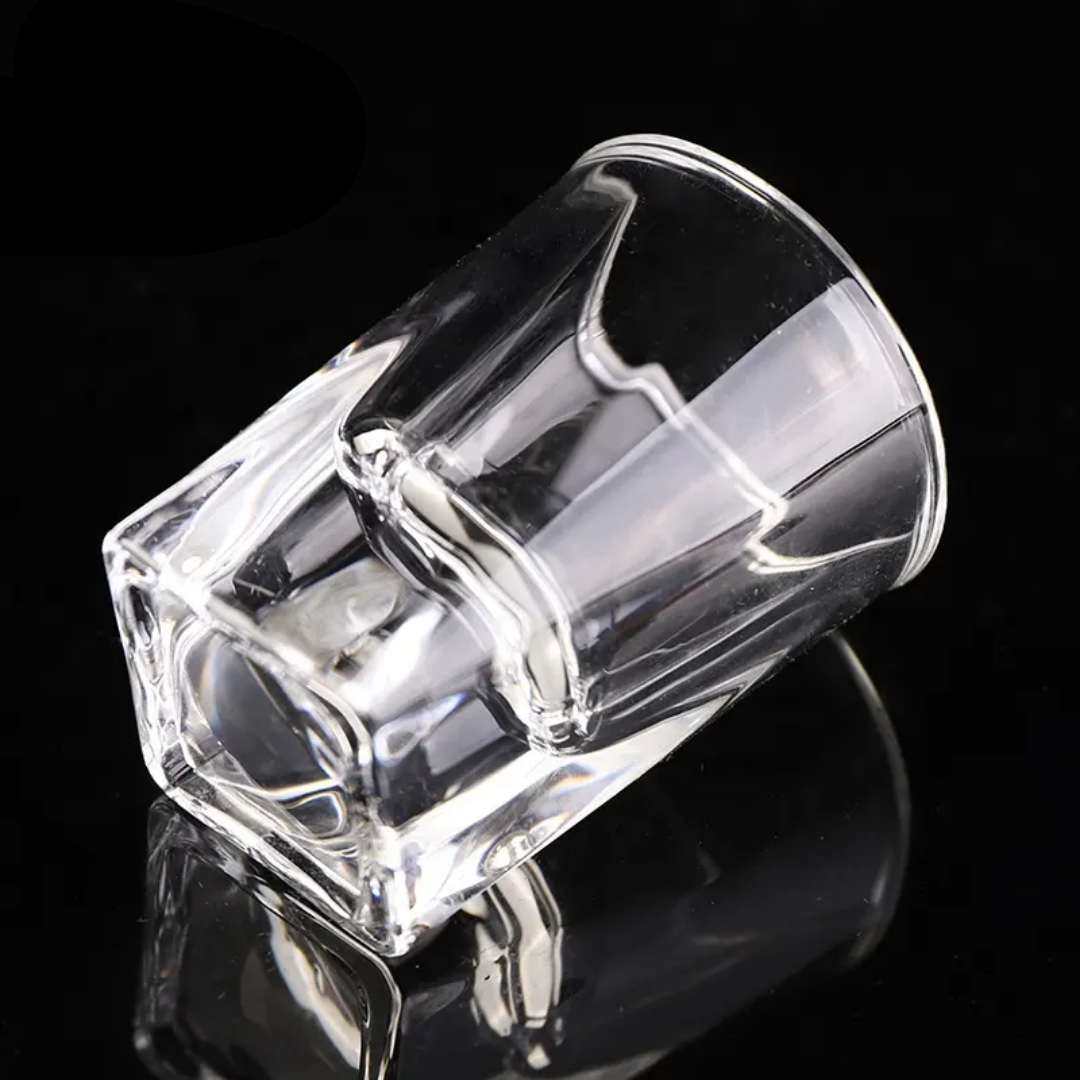 Durable clear shot glass with solid heavy base shown on black background, from Clear Heavy Base Shot Glasses 6 Pack at Bamagate.com.