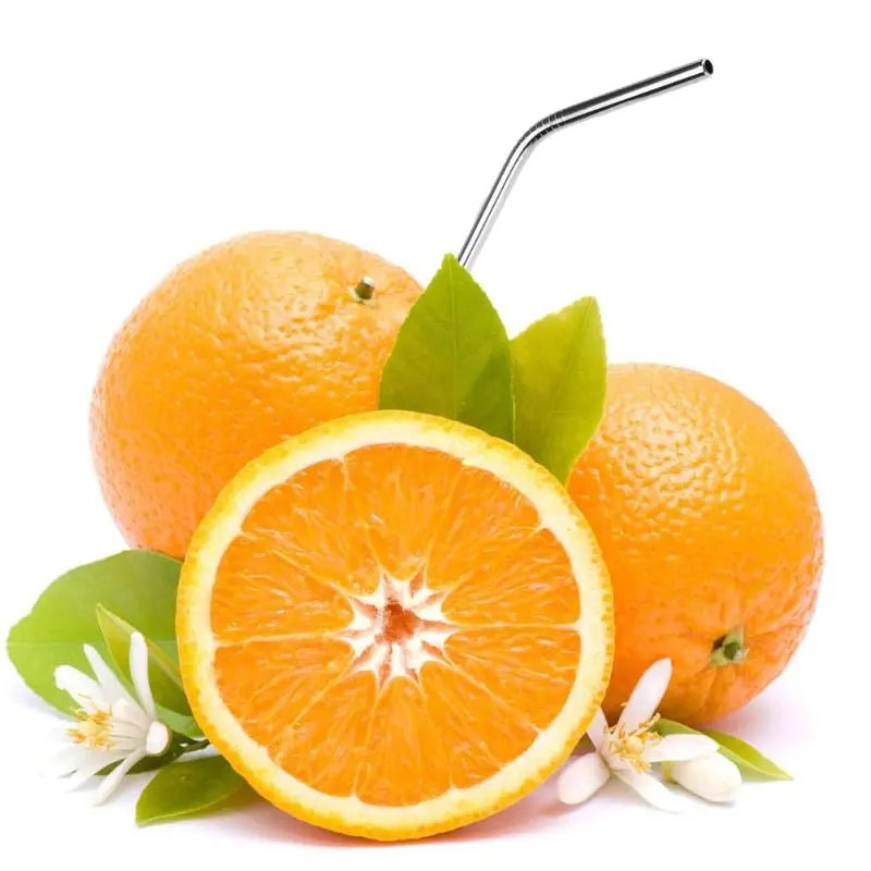 Stainless steel straw inserted into fresh oranges, symbolizing sustainability. Purchase reusable metal straws in Sri Lanka from Bamagate.com.