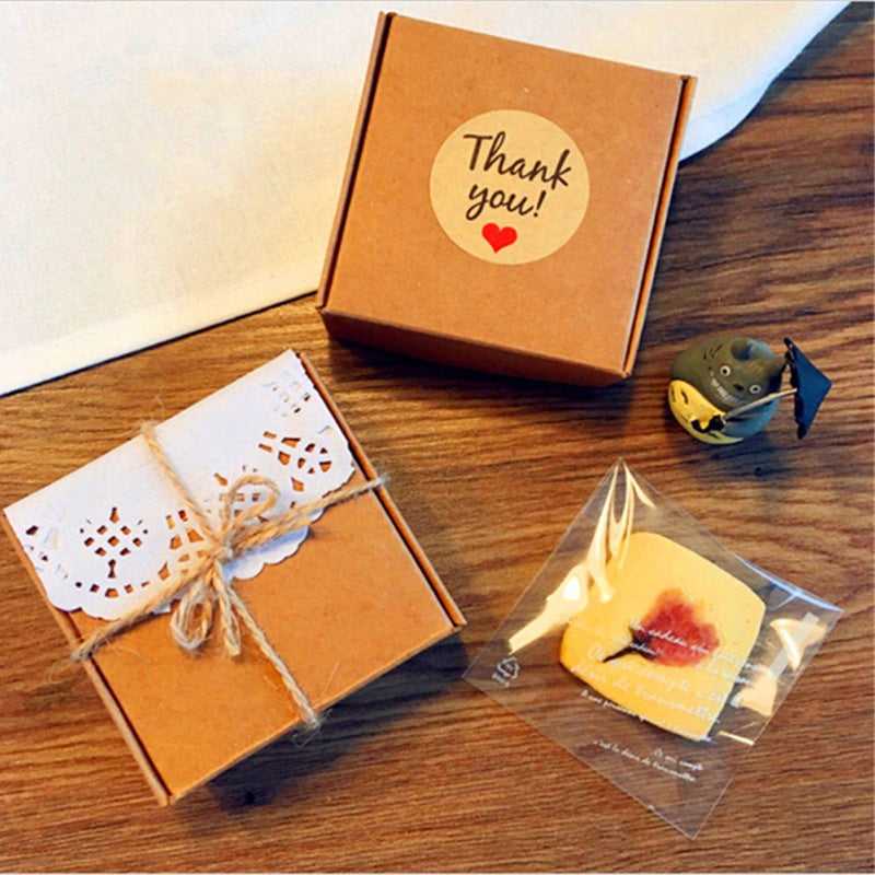 Kraft paper thank you sticker on gift boxes, perfect for enhancing packaging presentation in office supplies and party tags.