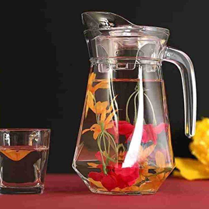 Elegant 1.4L glass water jug filled with floral-infused water, thermal-resistant and ideal for stylish drink presentation.