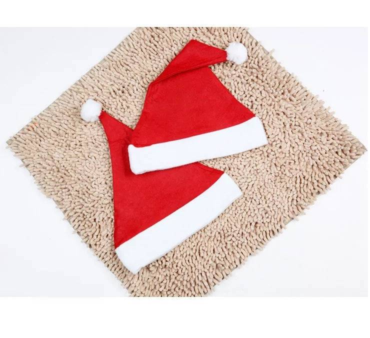 Christmas Velvet Santa Hat for Adults in red with white trim and pom-pom, displayed on beige textured mat. Size 32cm x 24cm, 1 piece pack.