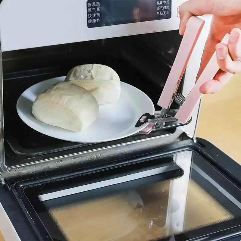 Anti-hot Plate Gripper Lifter Tongs removing a hot plate from a microwave, preventing burns during cooking. Shop kitchen safety tools in Sri Lanka.