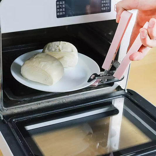 Anti-hot Plate Gripper Lifter Tongs removing a hot plate from a microwave, preventing burns during cooking. Shop kitchen safety tools in Sri Lanka.