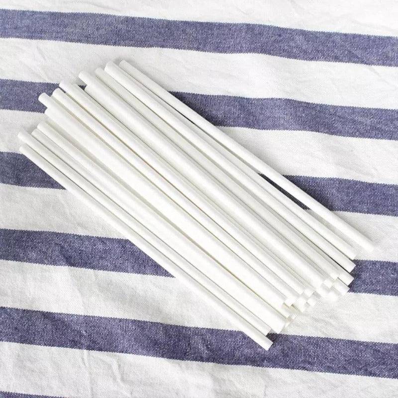 White 8mm biodegradable paper straws laid on striped fabric, 100 PCS pack for sustainable party and household use.
