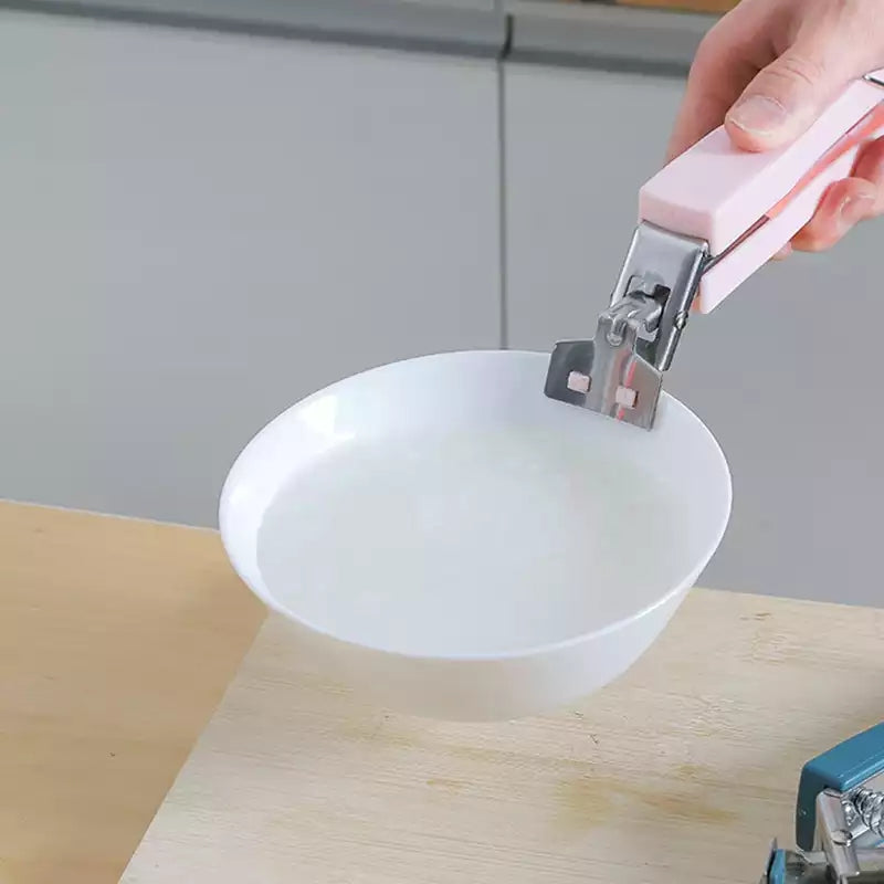 Pink-handled Anti-hot Plate Gripper Lifter Tongs lifting a hot bowl of soup, essential kitchen gadget for safe dish handling. Available online in Sri Lanka.