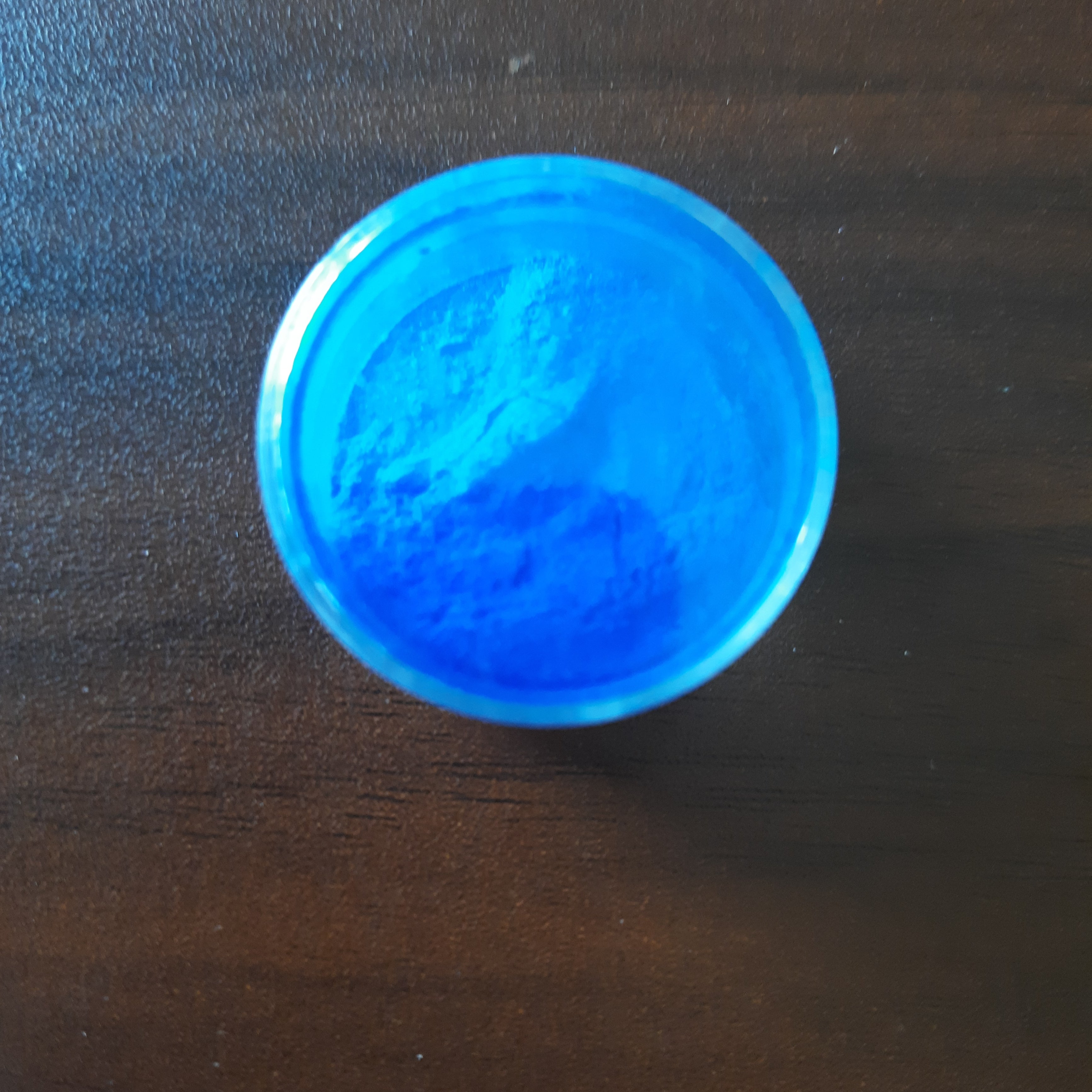 Bright blue edible dust powder in a container for cake decorating. Shop edible powder for baking at Bamagate.com.