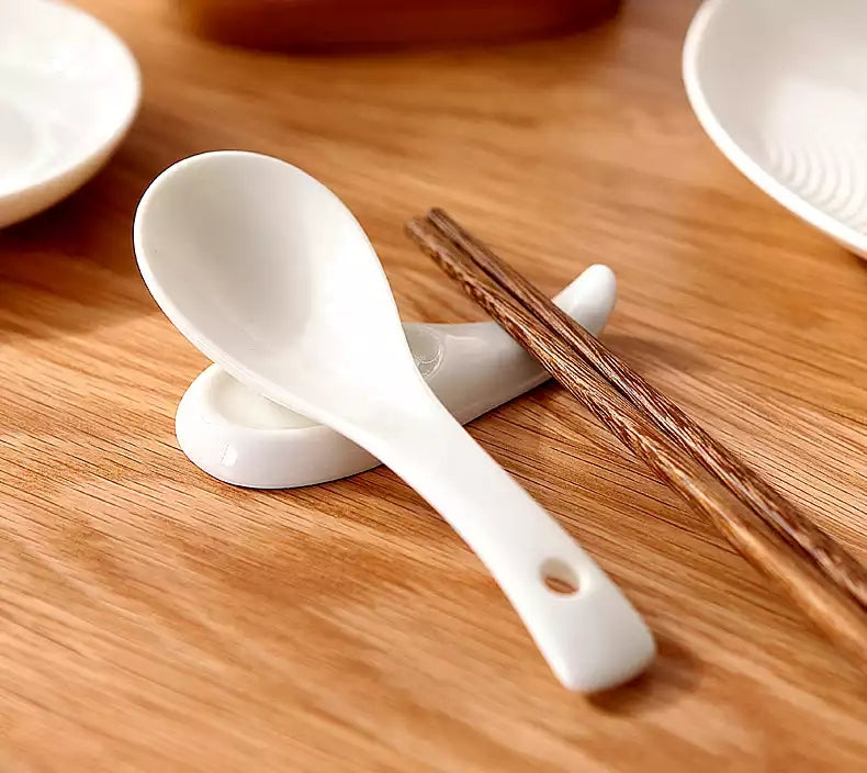 White Melamine Soup Spoon - Dishwasher Safe | 6x2 inches shown on a wooden table with chopsticks, ideal for home or restaurant dining.