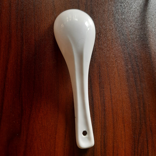 White Melamine Soup Spoon - Dishwasher Safe | 6x2 inches displayed on a dark wood surface, durable and suitable for everyday kitchen use.
