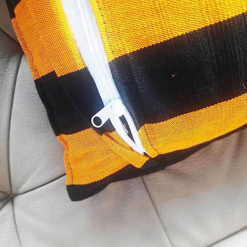 Close-up of zipper on Striped Handloom Cushion Cover - Black Orange, showing durable stitching and easy insert access for 16x16 inch pillows.
