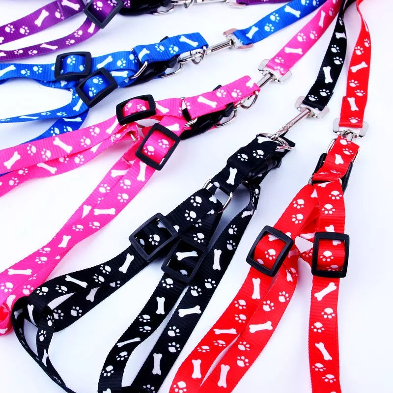 Colorful Puppy Small Dog Adjustable Harness Leash Set with paw and bone prints, ideal for pet care and control. Available in red, black, pink, and blue.