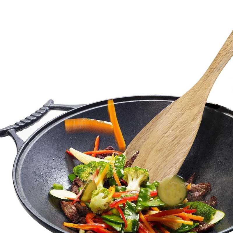 Bamboo wooden spatula stirring vegetables in a wok, nonstick safe and ideal for healthy cooking in Sri Lankan kitchens.