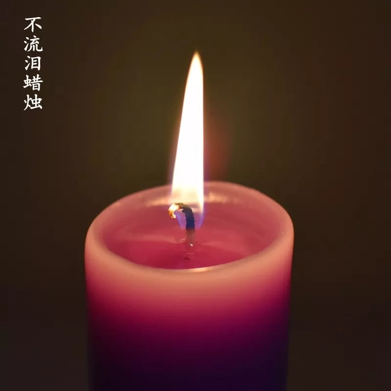 Lit purple pillar candle with steady flame, perfect for aromatherapy and spiritual rituals, part of Bamagate.com’s candle range in Sri Lanka.