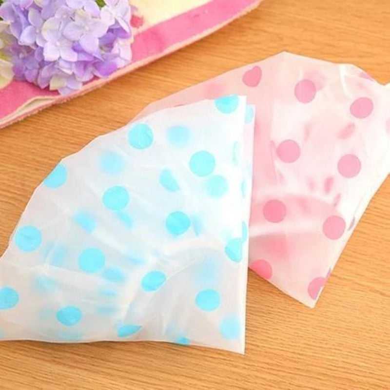 Folded waterproof shower caps in blue and pink polka dot designs, perfect for travel and daily use. Affordable shower cap in Sri Lanka.