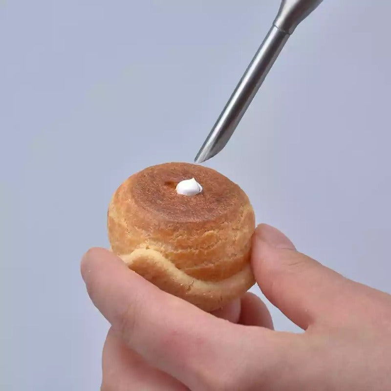 Cream Puff Nozzle Set in use filling cream into a round pastry. Great for decorating cupcakes, puffs, and other desserts.