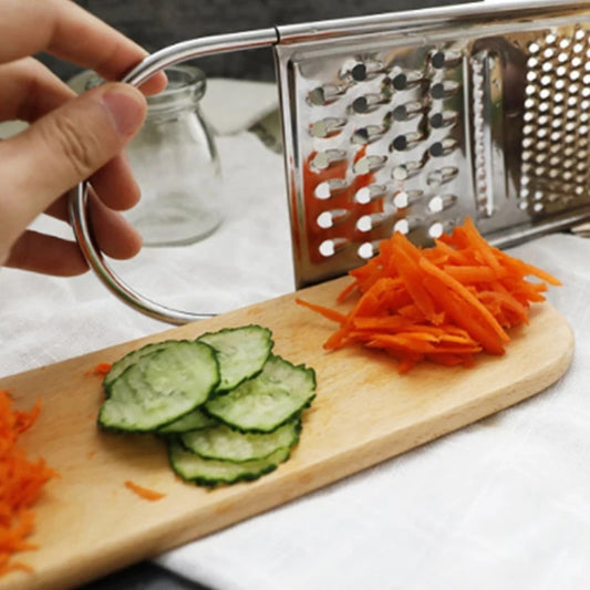 Stainless Steel Flat Vegetable Grater in use slicing carrots and cucumbers on a wooden board, essential kitchen gadget from Bamagate.com