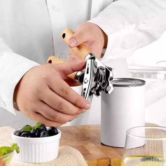Person using a wooden-handled Multifunctional Can Cutter Bottle Opener to open a tin can. Premium kitchen gadget under Can Bottle Opener Bottle Tin Cutter Price in Sri Lanka.