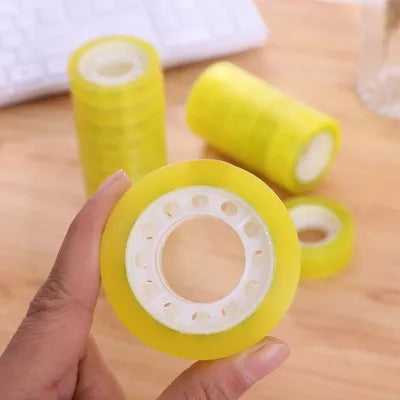 High-quality clear cello tape 1/2 inch held in hand, ideal for office use and packaging, available at Bamagate.com.
