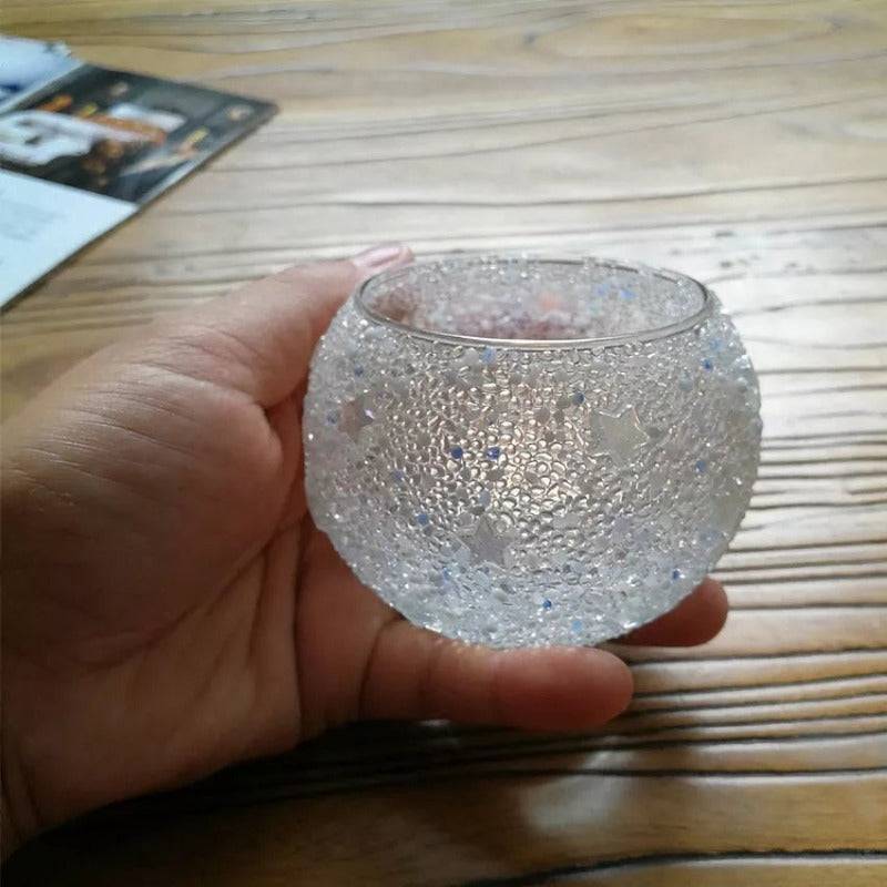 Hand holding large mosaic glass candle holder with star pattern, showcasing textured surface. Great for gifting or spiritual ambiance.