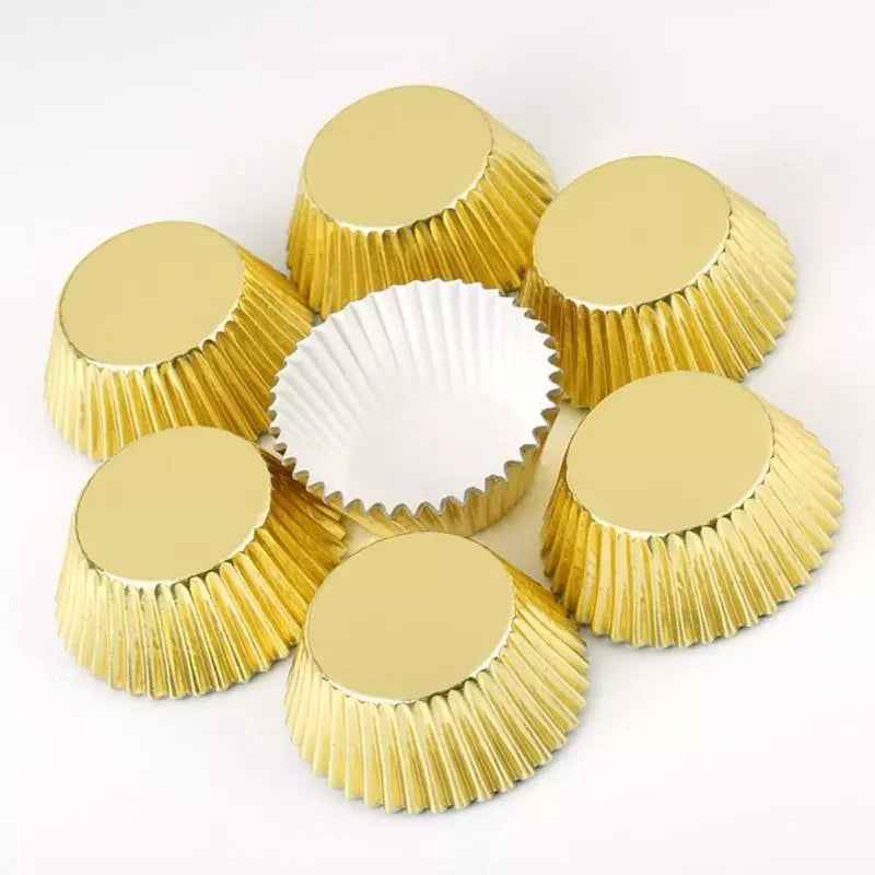 Set of gold cupcake liners arranged in a circle with one open to show white interior. Premium baking cups from Bamagate.com in Sri Lanka.
