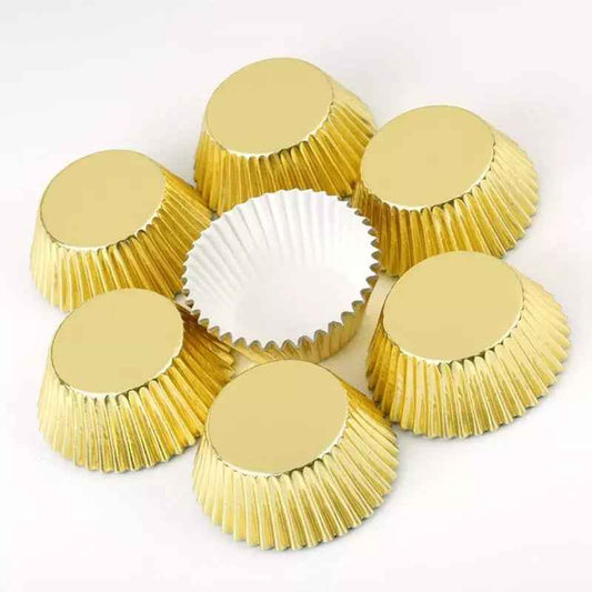 Set of gold cupcake liners arranged in a circle with one open to show white interior. Premium baking cups from Bamagate.com in Sri Lanka.