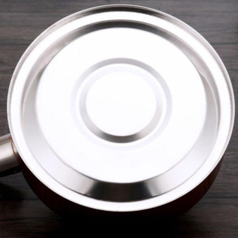 Close-up of the stainless steel kettle base designed for even heat distribution, compatible with multiple stove types.