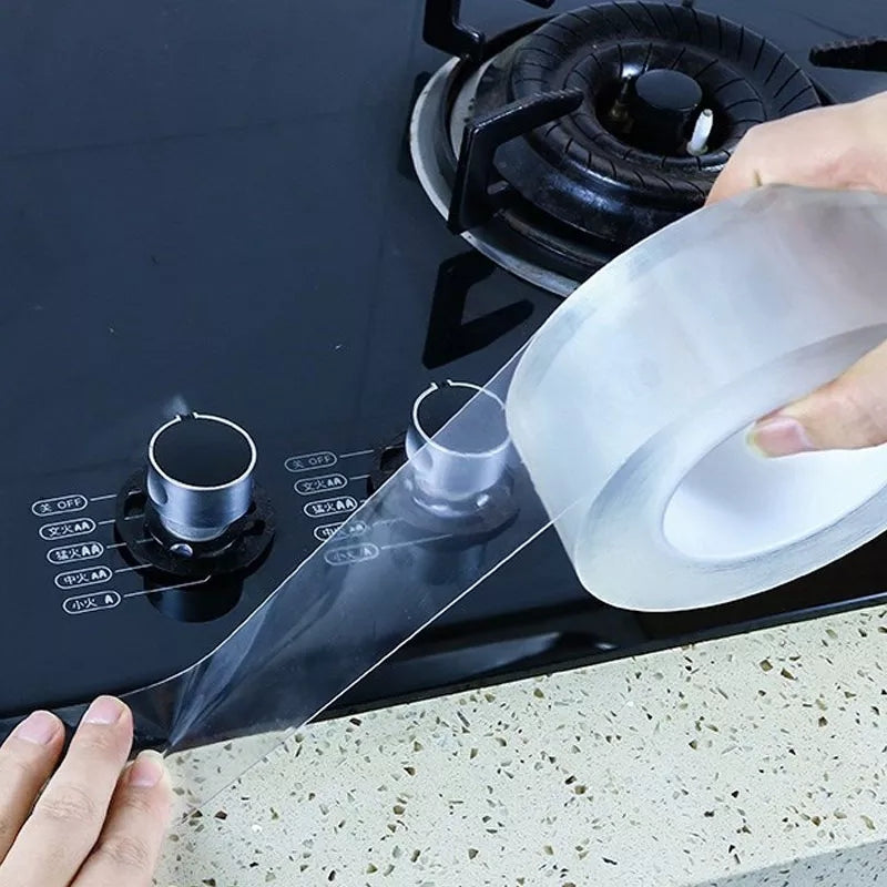 Transparent Sink Waterproof Adhesive Tape applied around a stove area, ideal for sealing and protecting kitchen surfaces from moisture and dirt.